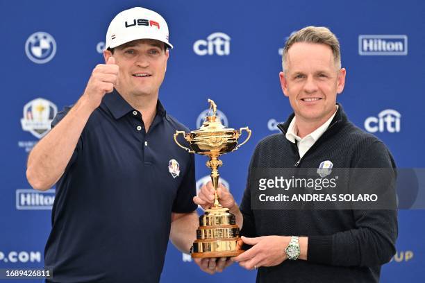 Europe's English captain, Luke Donald and US captain, Zach Johnson pose with the trophy at the end of a press conference ahead of the 44th Ryder Cup...