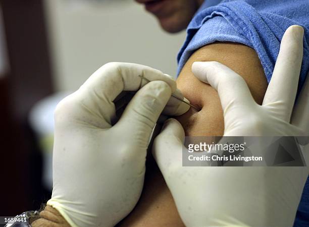 Dr. Ronald Brown administers a smallpox vaccine to Scott Christopher December 16, 2002 at Mid-Florida Biologicals in Altamonte Springs, Florida. The...