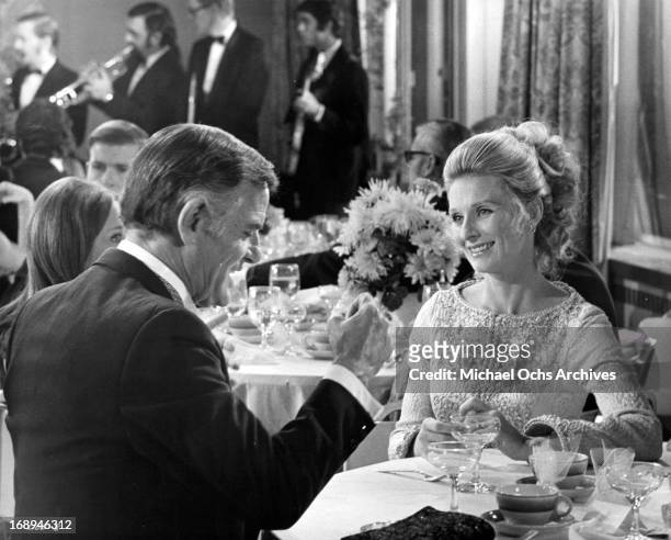 Gig Young has dinner with Cloris Leachman in a scene from the film 'Lovers And Other Strangers', 1970.