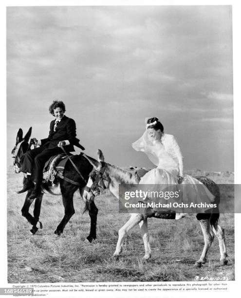 Timothy Bottoms rides with Maggie Smith in a scene from the film 'Love And Pain And The Whole Damn Thing', 1973.