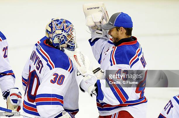 Henrik Lundqvist of the New York Rangers celebrates with Martin Biron after a 5-0 victory against the Washington Capitals in Game Seven of the...