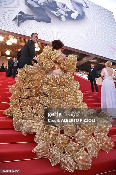 Guest, wearing a dress made of biscuit trays, arrives on May 17, 2013 for the screening of the film "The Past" presented in Competition at the 66th...