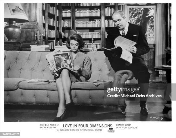 Sylva Koscina and Gastone Moschin read magazines in a scene from the film 'Love In Four Dimensions', 1964.