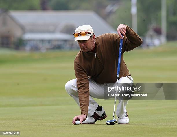 Iain Parker of Royal North Devon Golf Club places the ball during the final round of the Senior PGA Professional Championship at Northamptonshire...