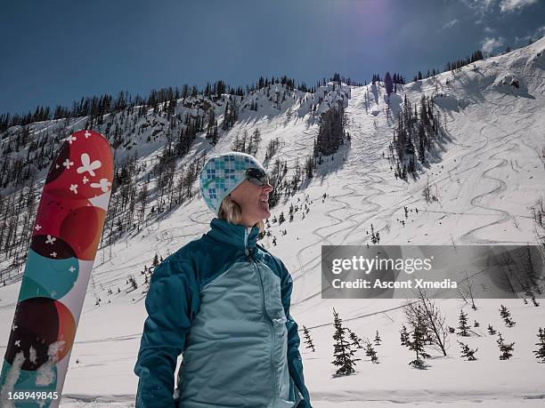 skier pauses below fresh powder tracks, looks out - ski hill stock pictures, royalty-free photos & images