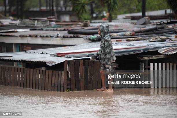 Boy walks on mud caused by a mudslide and heavy flooding as a result of a storm in Sir Lowry's Village, close Somerset West on September 25, 2023.