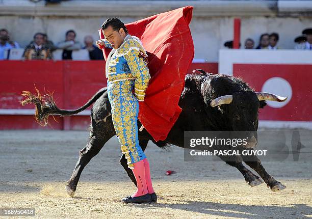 Spanish matador Ivan Fandino makes a muleta pass on a Jandilla's fighting bull on May 17, 2013 during the Nimes Pentecost Feria in Nimes,...