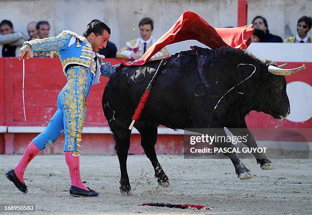 Spanish matador Ivan Fandino makes a muleta pass on a Jandilla's fighting bull on May 17, 2013 during the Nimes Pentecost Feria in Nimes,...