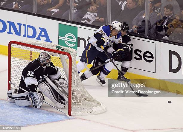 Goaltender Jonathan Quick of the Los Angeles Kings watches as Alex Steen of the St. Louis Blues and Slava Voynov of the Los Angeles Kings vie for...