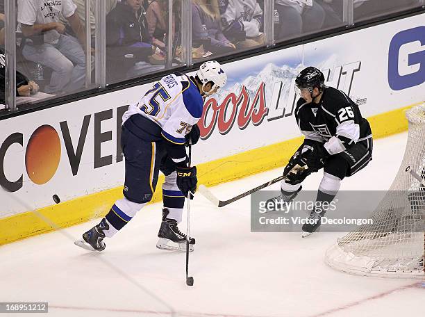 Ryan Reaves of the St. Louis Blues and Slava Voynov of the Los Angeles Kings vie for the puck behind the net during Game Six of the Western...