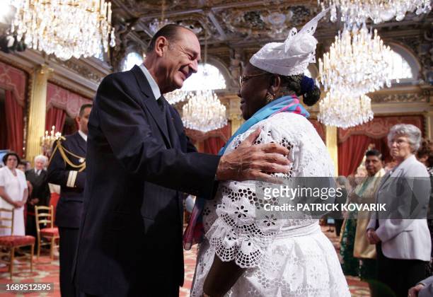 French president Jacques Chirac gives the gold medal to Sylvestre Marie-Lucrece Pineau from the Guadeloupe, during a medal award ceremony for the...