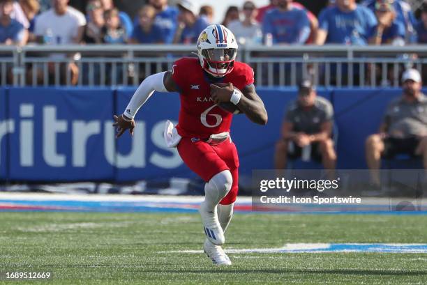 Kansas Jayhawks quarterback Jalon Daniels runs with the ball in the third quarter of a Big 12 football game between the Brigham Young Cougars and...