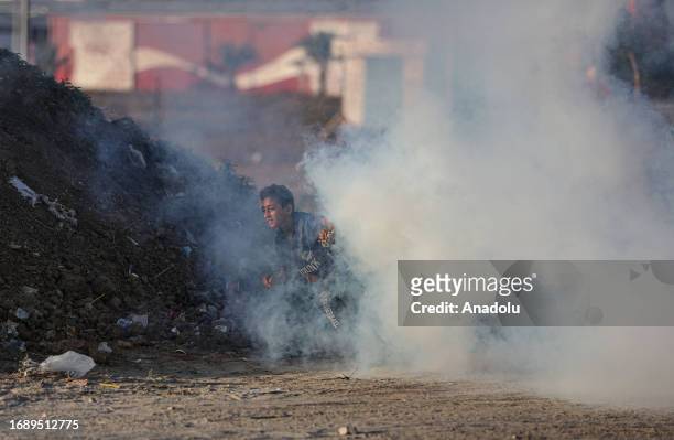 Palestinian child is seen in the smoke during the demonstration that has been going on for a week against Israeli forces' violations towards Al-Aqsa...