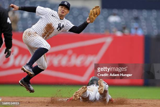 Christian Walker of the Arizona Diamondbacks steals second base below Anthony Volpe of the New York Yankees during the fifth inning at Yankee Stadium...