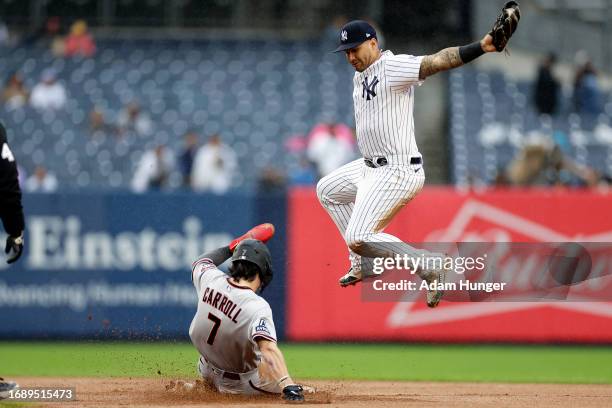 Corbin Carroll of the Arizona Diamondbacks steals second base below Gleyber Torres of the New York Yankees during the seventh inning at Yankee...