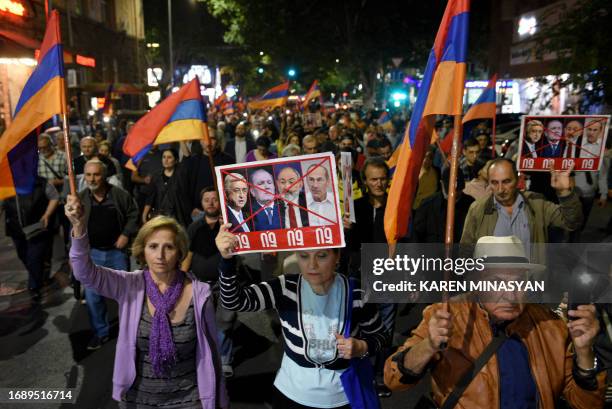 People take part in an anti-government rally in downtown Yerevan on September 25 following Azerbaijani military operations against Armenian...