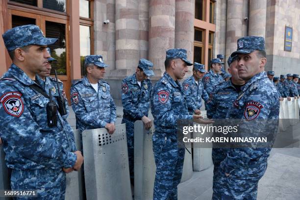 Armenian police officers stand guard during an anti-government rally in downtown Yerevan on September 25 following Azerbaijani military operations...