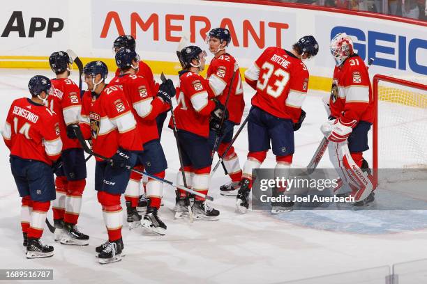 Teammates congratulate goaltender Ludovic Waeber Florida Panthers after the 5-0 win against the Nashville Predators during a preseason game at the...