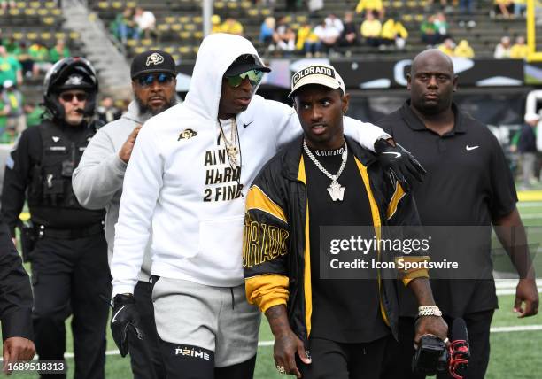 Colorado Buffaloes head coach Deion Sanders talks with his son Deion Jr. On the field during a PAC-12 conference football game between the Colorado...