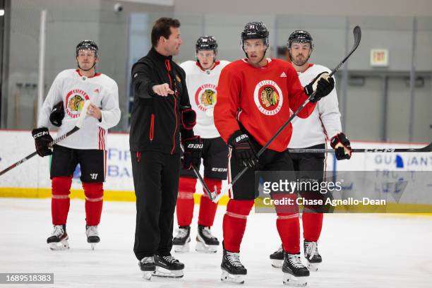 Taylor Hall of the Chicago Blackhawks talks with Head Coach Luke Richardson during practice at Fifth Third Arena on September 25, 2023 in Chicago,...