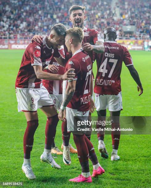 Claudiu Petrila of Rapid Bucuresti celebrates after scoring a goal with his teammate Albion Rrahmani during the SuperLiga Round 10 match between...