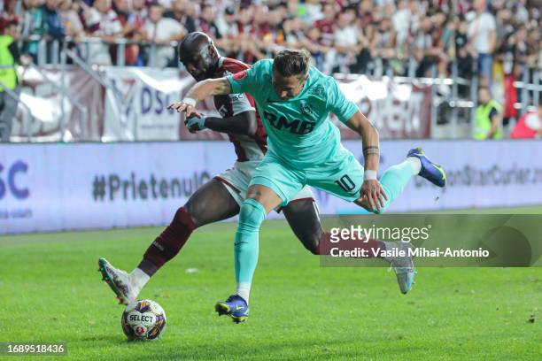 Ciprian Deac of CFR Cluj competes for the ball with Christopher Braun of Rapid Bucuresti during the SuperLiga Round 10 match between Rapid Bucuresti...