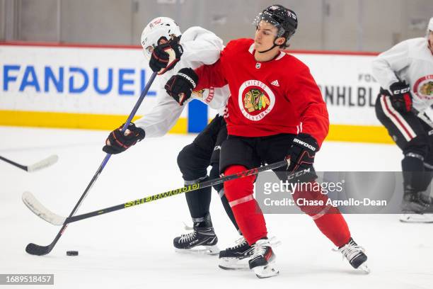 Connor Bedard of the Chicago Blackhawks hits Michal Teply of the Chicago Blackhawks during a scrimmage at Fifth Third Arena on September 25, 2023 in...