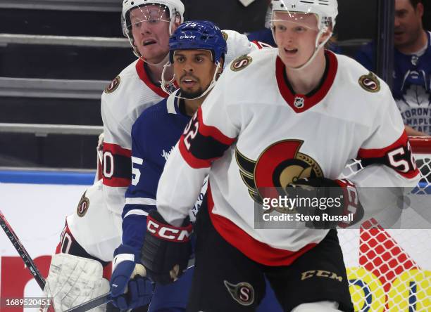 Toronto Maple Leafs right wing Ryan Reaves battles for position with Ottawa Senators defenseman Maxence Guenette and Ottawa Senators left wing Roby...