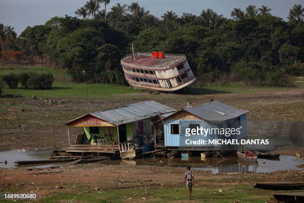Houseboats and a stranded boat are seen on the Rio Negro, in the Cacau Pirera District, in Iranduba, Amazonas, Brazil, on September 25, 2023. The...