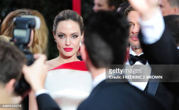Actors Angelina Jolie and Brad Pitt arrive on the red carpet for the 69th annual Golden Globe Awards at the Beverly Hilton Hotel in Beverly Hills,...