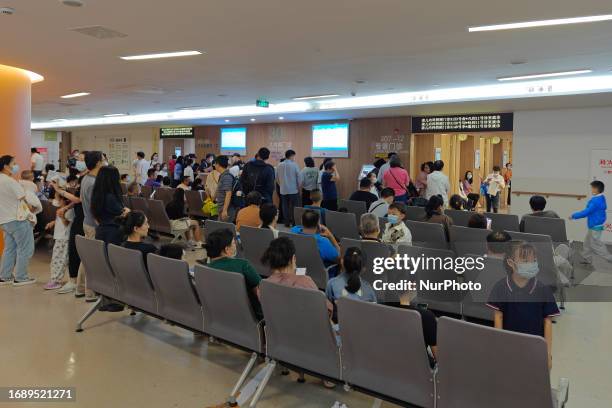 Patients line up for an emergency pre-check at the new pediatric building of Xinhua Hospital in Shanghai, China, On the night of September 25, 2023....