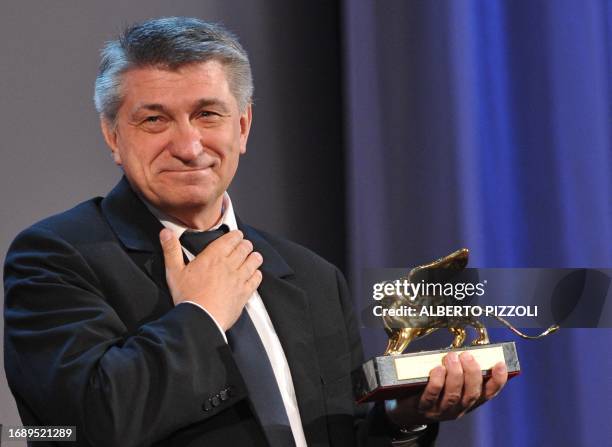 Russian film director Alexander Sokurov reacts after being awarded with the Golden Lion for best film for "Faust" during the award ceremony at the...