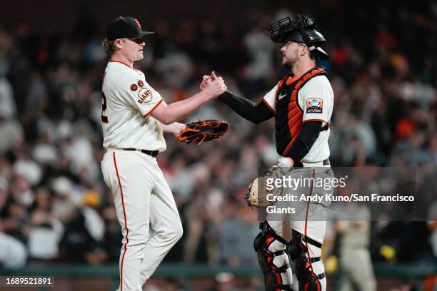 Logan Webb and Patrick Bailey of the San Francisco Giants celebrate a win against the San Diego Padres at Oracle Park on September 25, 2023 in San...