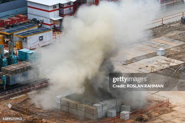 Smoke rises after a 100kg World War II-era aerial bomb is detonated at a construction site in Singapore on September 26, 2023.
