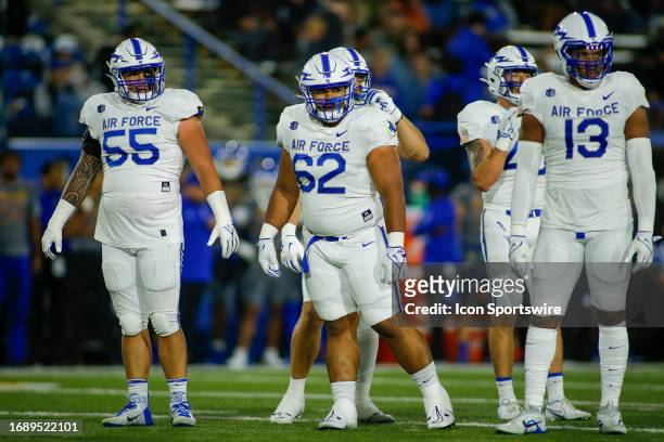 Air Force NG Kupono Blake , Air Force DL James Tomasi , and Air Force DE PJ Ramsey look for the next play in the game between the Air Force Falcons...