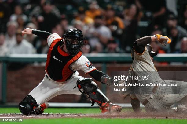Patrick Bailey of the San Francisco Giants tags out at home in a game against the San Diego Padres at Oracle Park on September 25, 2023 in San...
