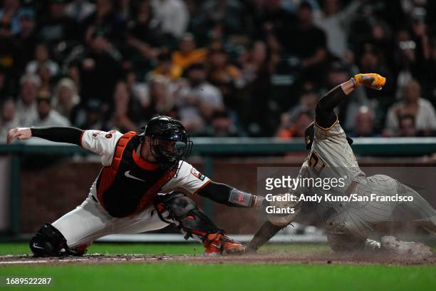 Patrick Bailey of the San Francisco Giants tags out at home in a game against the San Diego Padres at Oracle Park on September 25, 2023 in San...