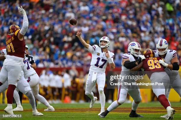 Buffalo Bills quarterback Josh Allen throws a touchdown pass during the first quarter of the game against the Washington Commanders at FedEx Field on...