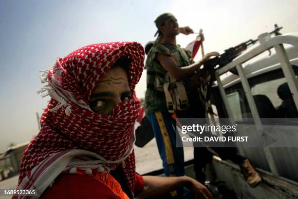 Iraqi Sunni "volunteers", former insurgents who have joined forces with US and Iraqi troops against Al-Qaeda in Iraq, sit on a pickup truck before...