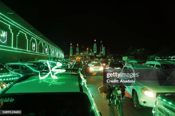 Mosques, vehicles and buildings are illuminated with green lights during Mawlid al-Nabi celebrations in Sanaa, Yemen on September 25, 2023.