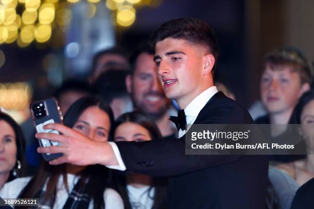 Harry Sheezel of the Kangaroos takes a selfie with fans during the 2023 Brownlow Medal at Crown Palladium on September 25, 2023 in Melbourne,...