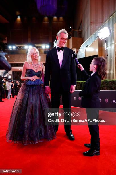 Darcy Moore of the Magpies and partner Dee Salmin are interviewed by Archie Stockdale during the 2023 Brownlow Medal at Crown Palladium on September...