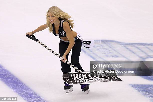 An L.A. Kings ice girl skates to the exit during a break in action of Game Six of the Western Conference Quarterfinals between the St. Louis Blues...