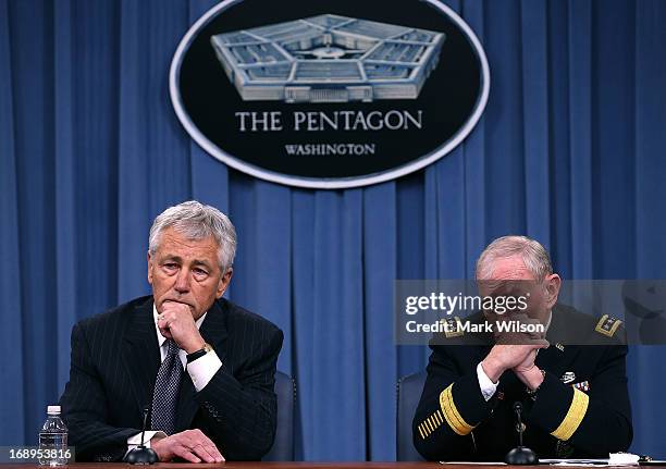 Secretary of Defense Chuck Hagel and Chairman of the Joint Chiefs of Staff Gen. Martin E. Dempsey listen to questions during a media briefing at the...