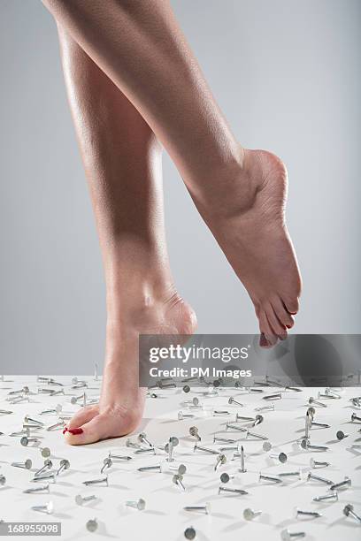 woman's bare feet with nails on floor - womans bare feet fotografías e imágenes de stock