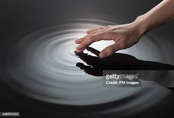 woman's hand touching water - touching photos et images de collection
