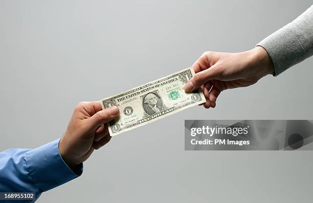 two hands holding a dollar - american one dollar bill fotografías e imágenes de stock