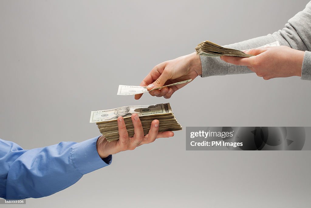 Woman handing man money