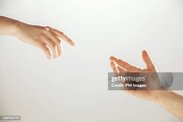 hands reaching towards each other - 手を伸ばす 女性 ストックフォトと画像