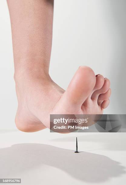 about to step on nail - voetzool stockfoto's en -beelden